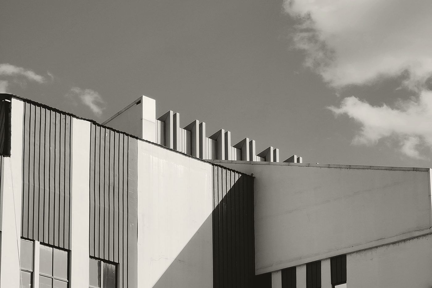 Black-and-white photograph of a modern building's geometric facade